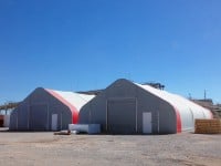 Industrial warehouse fabric structure with roll-up door