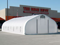 A 17' wide x 40' long HGB Series™ retail greenhouse from Alaska Structures® is used by Home Depot in Indiana for an outdoor garden display, anchored directly to the asphalt in the parking lot.