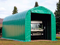 An RV is securely parked inside a ground -anchored WeatherPort® RV Carport, featuring a heavy - duty double zipper entry and durable green fabric for all - weather protection.