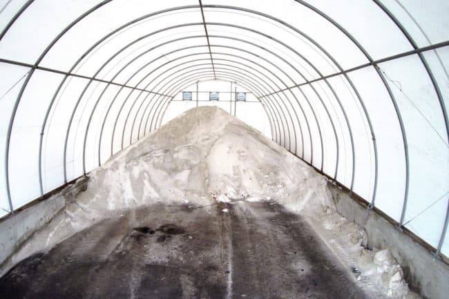 Interior of a SQ Series™ fabric building from Alaska Structures® protects salt from adverse weather.