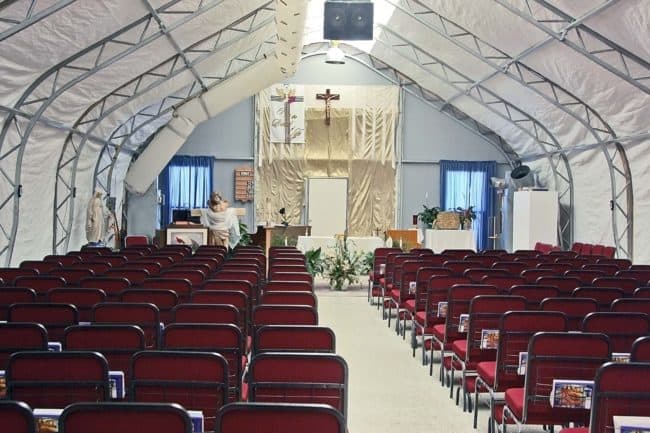 alaska-structures-church-builldings-dagb-fabric-building-2 The spacious interior of a temporary worship facility utilizing a DAGB Series™ pre-engineered building from Alaska Structures®.