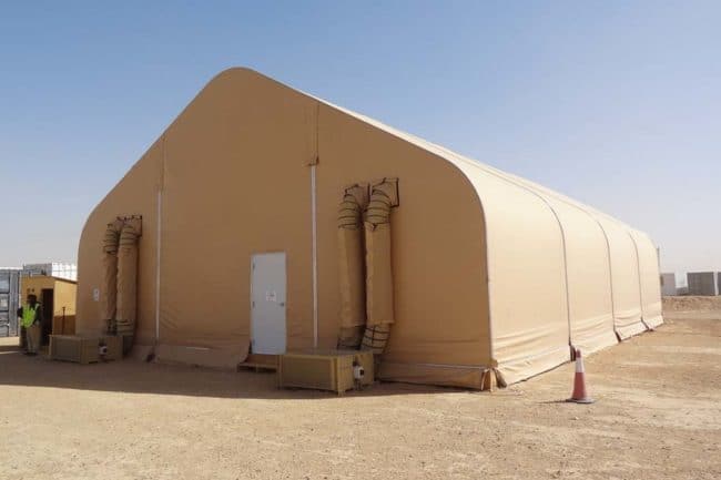 DAGB fabric building for on-site modular offices in arid climate An onsite modular office at a remote mining camp is equipped with two 5-ton Alaska ECUs® from Alaska Structures®, ensuring a temperature-controlled interior that withstands the extreme desert heat.