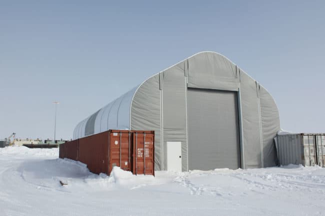 Alaska Structures DAGB fabric building on containers for industrial workshop An industrial workshop on Alaska's North Slope utilizes a DAGB Series™ fabric building anchored to shipping containers, creating a hard -sided storage facility with an expansive central area ideal for welding larger equipment.