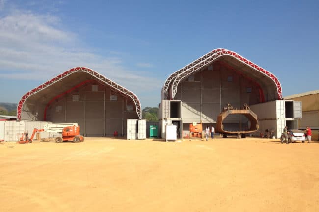 Alaska Structures DAGB fabric building on containers for industrial workshop A series of industrial work buildings mounted on shipping containers provides the necessary clearance for refitting large mining equipment at a remote site in Brazil, featuring DAGB Series™ fabric buildings from Alaska Structures®. The workshop on the right includes a rail system, allowing the inner fabric building to extend and offer additional coverage for extensive refitting projects.