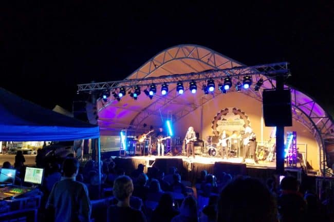 A large fabric building (DAGB Series™) from Alaska Structures is used as a stage cover.