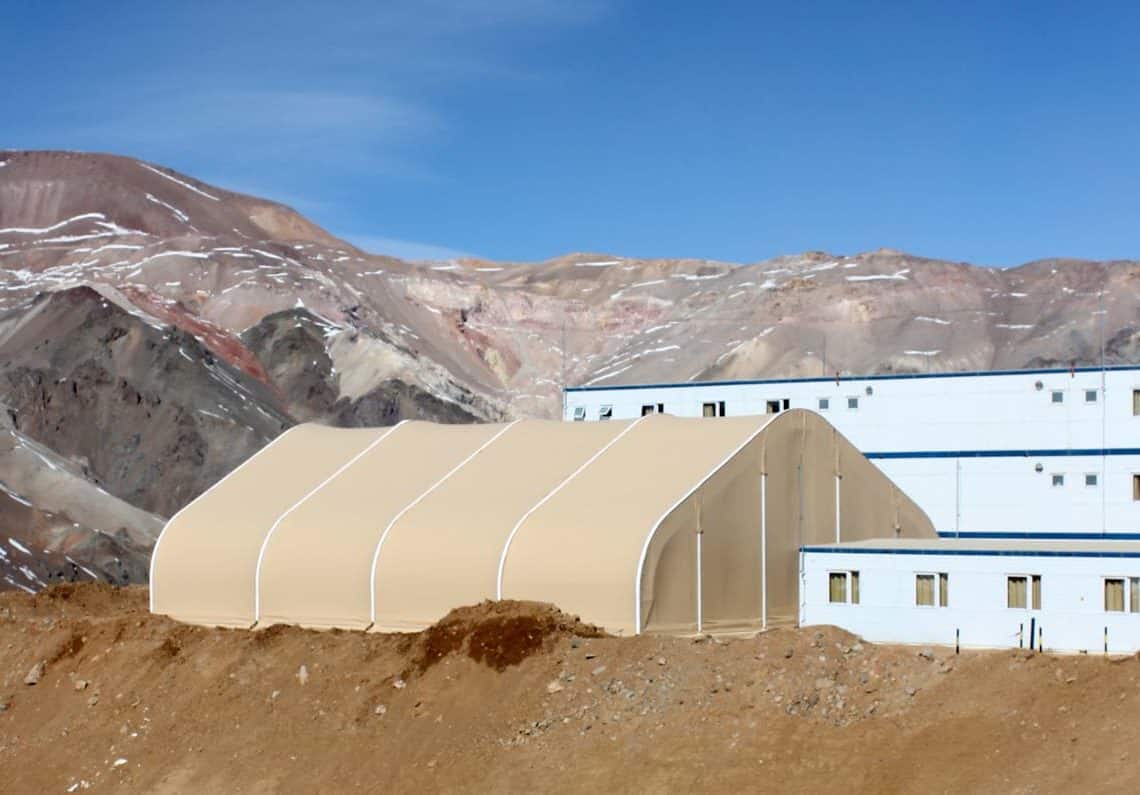 A high-altitude mining operation in Chile utilizes a large prefabricated building from Alaska Structures® as a dining hall, providing a durable and comfortable space to feed workers and crews.
