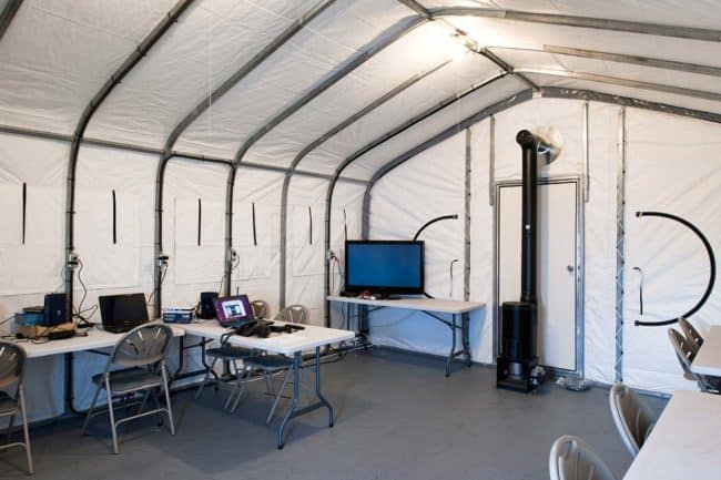 alaska-structures-gb-fabric-shelter-for-field-offices-2 The interior of a GB Series™ fabric building, used as a field office by an exploration company in Canada, includes an oil stove heater to ensure a comfortable working environment for workers.