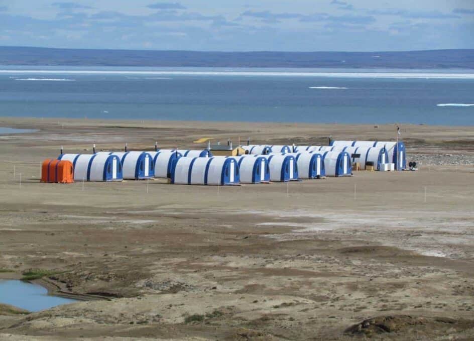 Alaska Structures GB survival shelter The bright orange color of the GB Series™ survival shelter at this exploration camp ensures easy visibility for workers in remote areas during adverse weather or near white-out conditions, offering a heated and protected refuge during life-threatening storms.