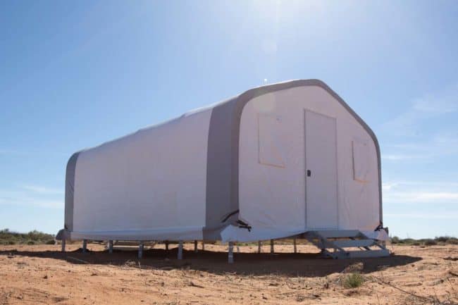 A 4-person mine dry facility uses a GB Series™ fabric building with a raised modular floor system from Alaska Structures®, enabling installation over uneven terrain.