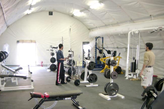 Alaska Structures workout center for mining camp A SQ Series™ fabric building from Alaska Structures® provides work crews at a remote mine site with a safe, temperature-controlled area for exercise, ensuring comfort and well-being in challenging environments.