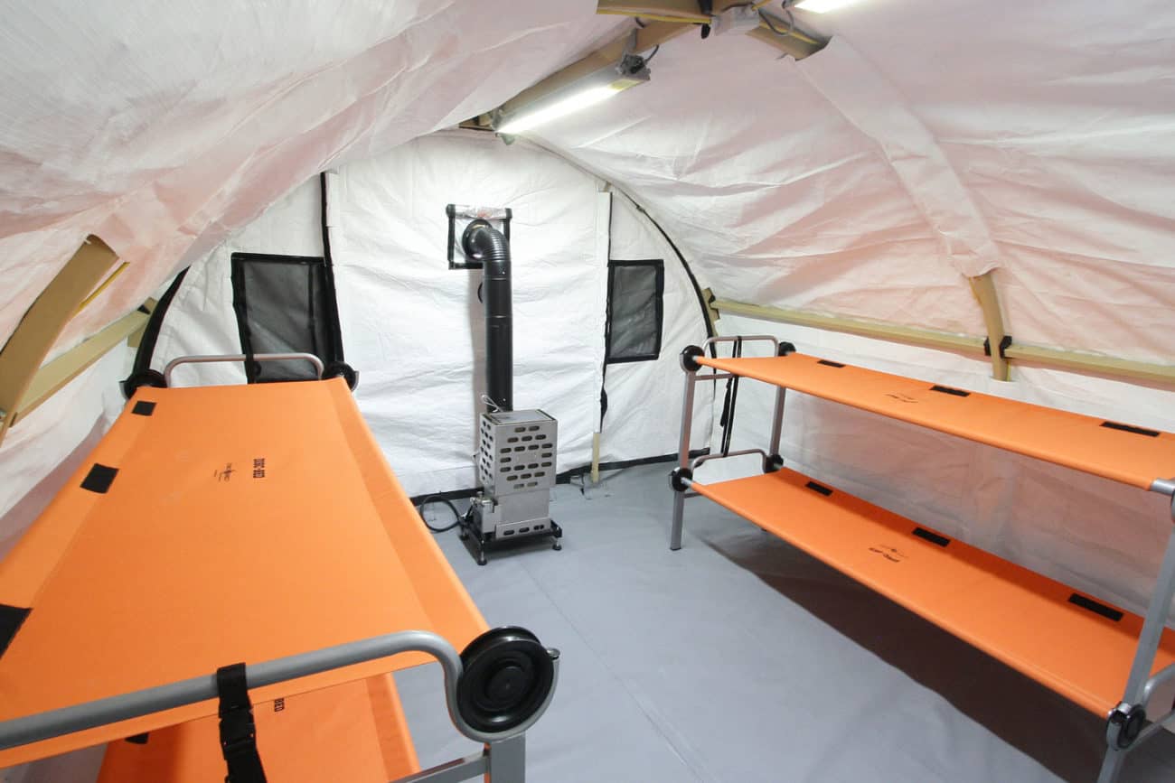 4-person sleeper using a 12’ x 13’ XPL Series quick-erect fabric shelter with portable beds and an oil stove.