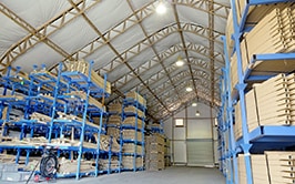 The inside of a large fabric warehouse filled with shelves and equipment