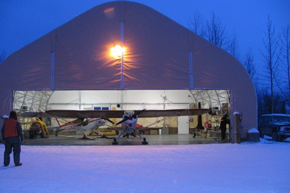 Fabric structure aircraft hangar with airplane in doorway