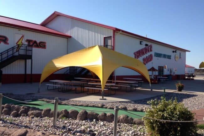 weatherport-canopy-20x20-thunder-road-of-fargo-1 Thunder Road Family Fun Park in Fargo, North Dakota, uses a 20’ x 20’ WeatherPort® Canopy to provide covered outdoor seating.