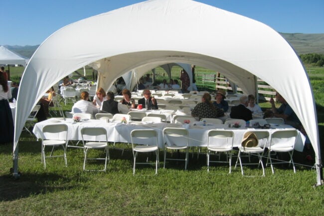 weatherport-4-sided-canopy-used-for-outdoor-event-1 An outdoor wedding uses a series of WeatherPort® event structures to provide guests with covered sitting areas.