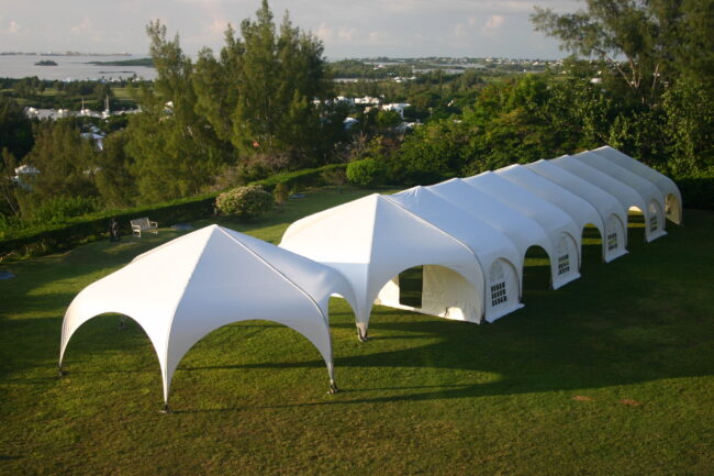 weatherport-jubilee-series-outdoor-event-structure-1 A 16’ x 16’ WeatherPort® Canopy provides guests with a covered seating area at an outdoor event.