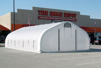 A 17' wide x 40' long HGB Series™ retail greenhouse from Alaska Structures® is used by Home Depot in Indiana for an outdoor garden display, anchored directly to the asphalt in the parking lot.