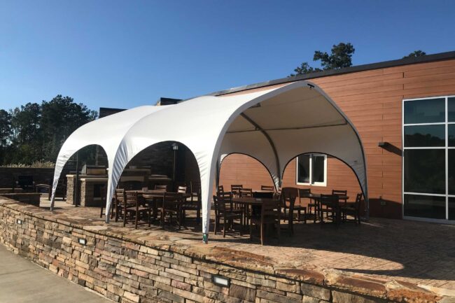 open-air-lunch-tent-from-alaska-structures-1 A lunch tent at Impact 360 Institute in Pine Mountain, Georgia provides staff and students with a shaded space to enjoy meals and gather during breaks, offering comfort and relaxation.