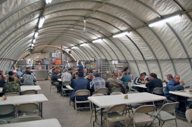 temperature-controlled-lunch-and-break-area-structures-from-alaska-structures-3 An SQ Series™ fabric building from Alaska Structures® serves as a dining hall and break area for workers at a remote mine site in Northern Siberia, providing a durable and comfortable space in harsh conditions.
