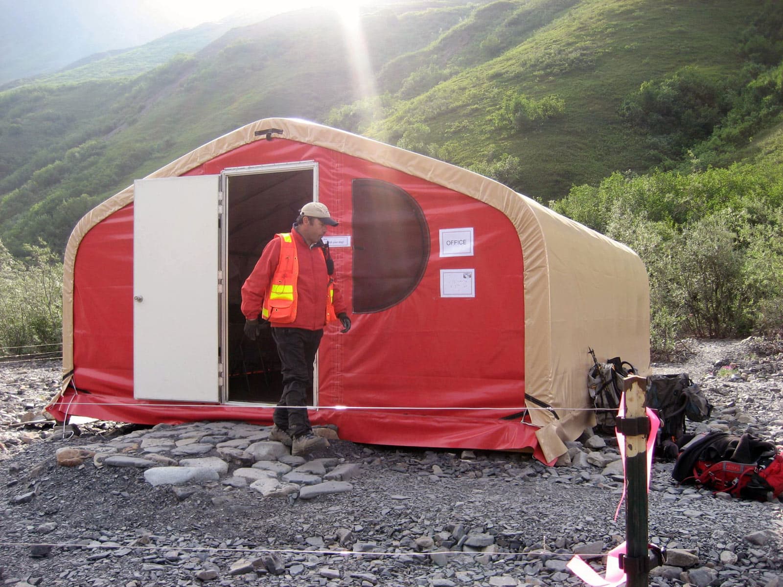 field-office-of-an-exploration-camp-using-gb-series-fabric-buildings-from-alaska-structures-1 Field office at an exploration camp supporting remote geological and survey operations. The structure features a GB Series™ pre-engineered fabric building from Alaska Structures®, providing a durable, rapidly deployable workspace for field coordination, data analysis, and project management in rugged terrain.