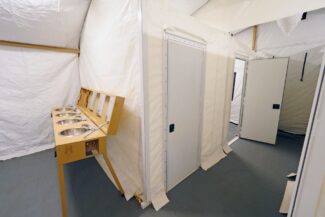 interior-of-a-portable-shower-facility-with-private-rooms-using-softwall-partitions-in-fabric-building-from-alaska-structures-2