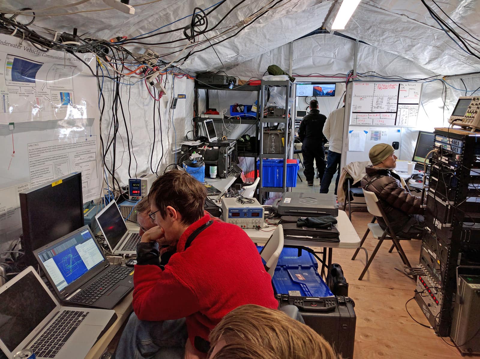 interior-of-a-rapidly-deployable-field-office-for-ICEX-2016-using-a-gb-series-fabric-building-from-alaska-structures-1. Interior of a modular field office from Alaska Structures®, configured as a command and communications center supporting engineering analysis, data monitoring, and mission coordination during ICEX 2016 Arctic operations.