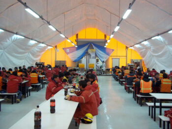 Fabric building dining facility connected to a containerized kitchen at a high-altitude Andes mining camp